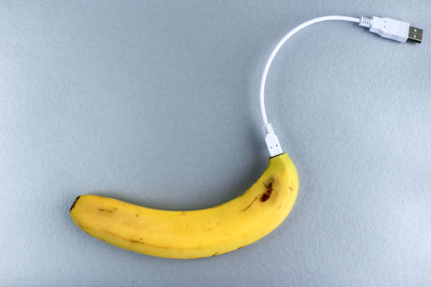 istock A fresh ripe banana connecting with a white usb charge cable on silver paper textured background. Concept of alternative electricity source, battery charger indicator, energy, healthy food, sex. 1254954804