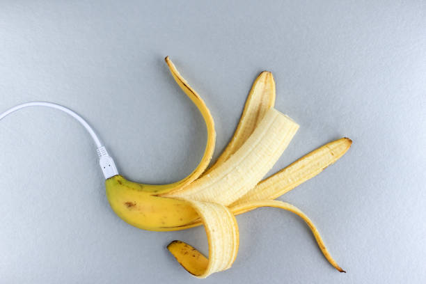 istock A fresh ripe banana connecting with a white usb charge cable on silver paper textured background. Concept of alternative electricity source, battery charger indicator, energy, healthy food, sex. 1254954830