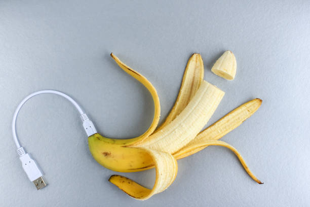istock A fresh ripe banana connecting with a white usb charge cable on silver paper textured background. Concept of alternative electricity source, battery charger indicator, energy, healthy food, sex. 1254954835