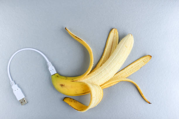 istock A fresh ripe banana connecting with a white usb charge cable on silver paper textured background. Concept of alternative electricity source, battery charger indicator, energy, healthy food, sex. 1254954846