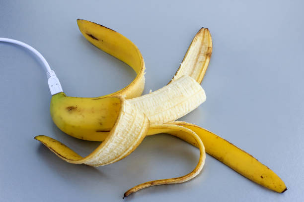 istock A fresh ripe banana connecting with a white usb charge cable on silver paper textured background. Concept of alternative electricity source, battery charger indicator, energy, healthy food, sex. 1254954890
