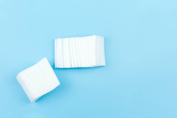 istock Cotton pad isolated on blue background with copy space 1254955218