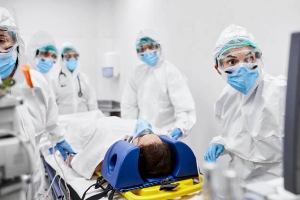 istock Doctors and Nurses Treating Female Patient in ICU 1254958288