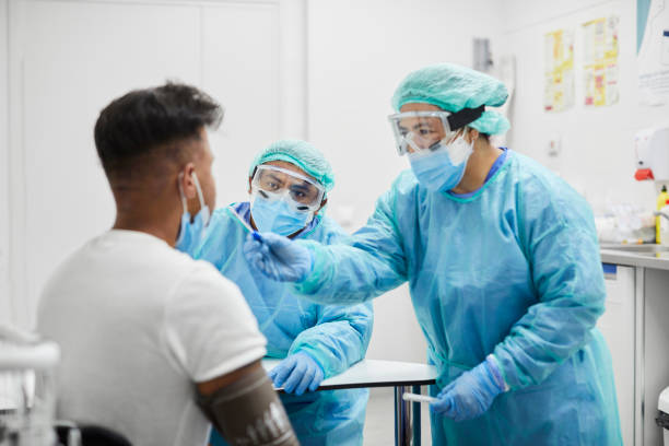 istock Female Doctor Taking Coronavirus Sample From Man, PCR 1254958305