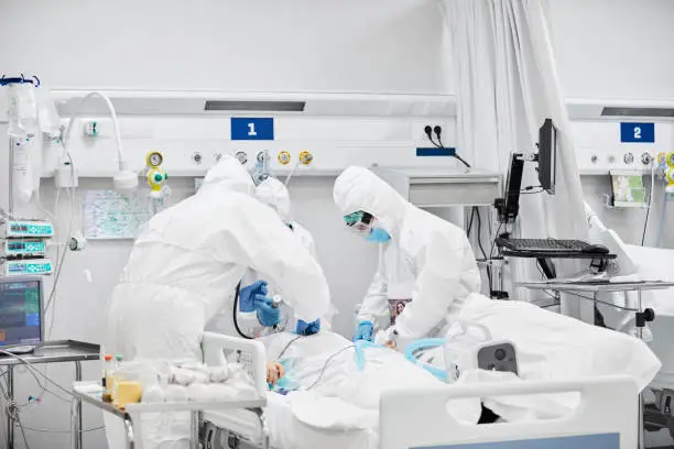 Photo of Frontline Workers Treating Male Patient in ICU