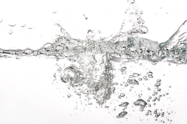 istock Water splashing as it's poured into tank, white background 1254959059
