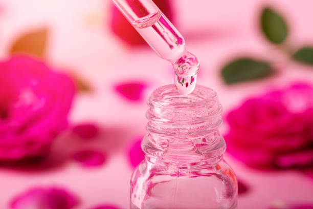 istock dropper with rose flower essential oil drop over the bottle 1254960061