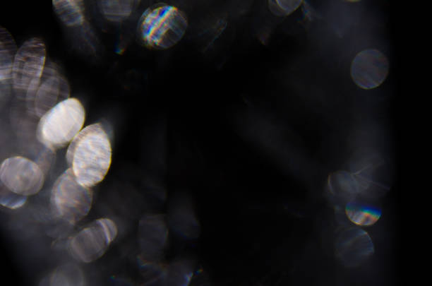 istock Flare lens, abstract light pattern for design as texture on black background. White bokeh, defocused shining colorful rainbow light leaks 1254960286