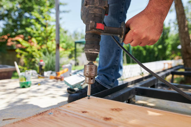 istock Hardworking handyman using drill to conect timbers into wooden board 1254961727
