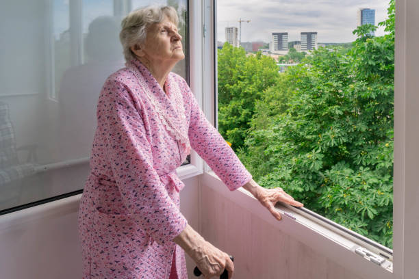 istock Senior woman looking at trees from her home balcony 1254961794