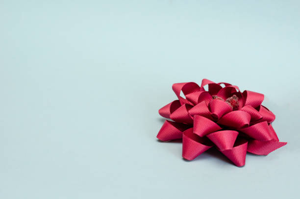 istock Abstract geometric shape from a satin ribbon on a light blue background. 1254962433