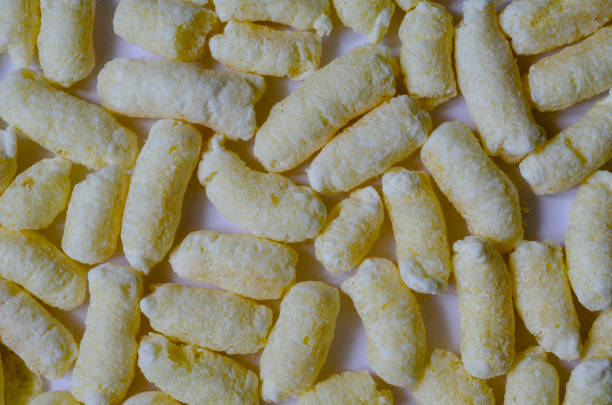 istock Airy Crisps, Corn Puffs, Puffcorn Snacks Background 1254962562