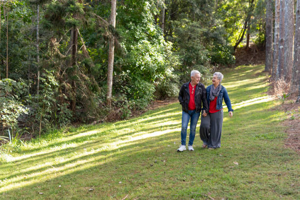 istock Happy Senior Couple Walking in a Forest 1254962783