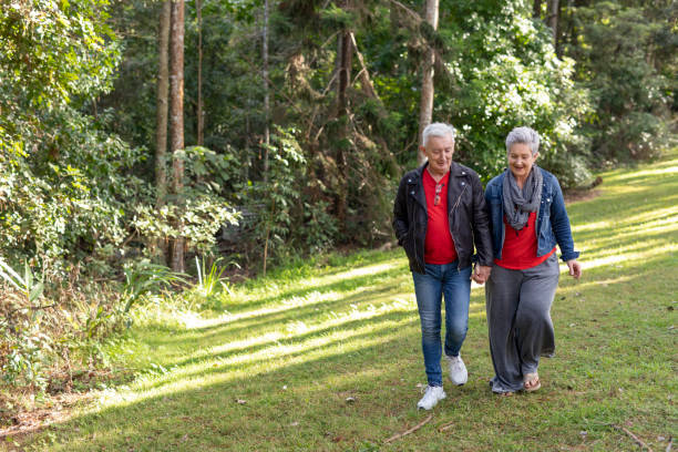 istock Happy Senior Couple Walking in a Forest 1254962785