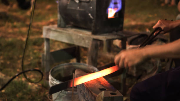 istock Blacksmith making hitting sword handmade traditional craftmanship show event 1254963126