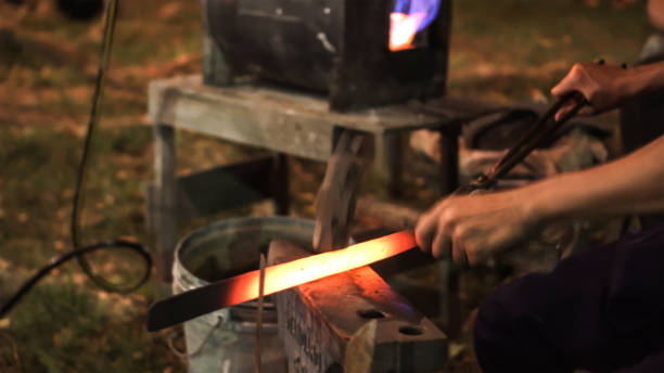 istock Blacksmith making hitting sword handmade traditional craftmanship show event 1254963151