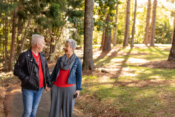 istock Happy Mature Couple Walking in a Forest 1254964259