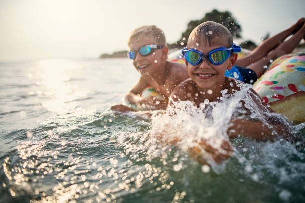 istock Little boys having fun playing in sea 1254964595
