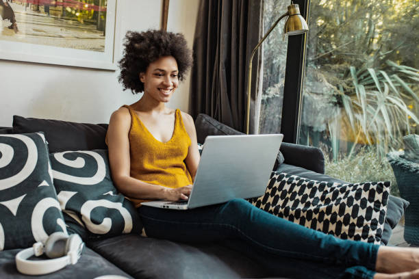 A woman is working from home on a laptop