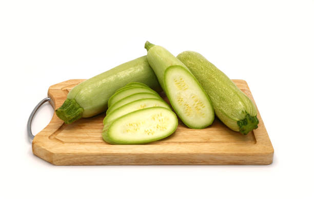 istock Whole and cut zucchini on a cutting board on a light background. 1254968865