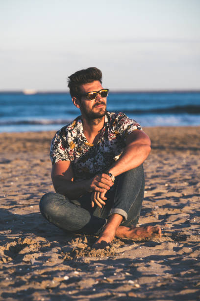 istock Young man at the beach 1254969439