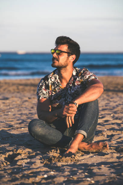 istock Young man at the beach 1254969457