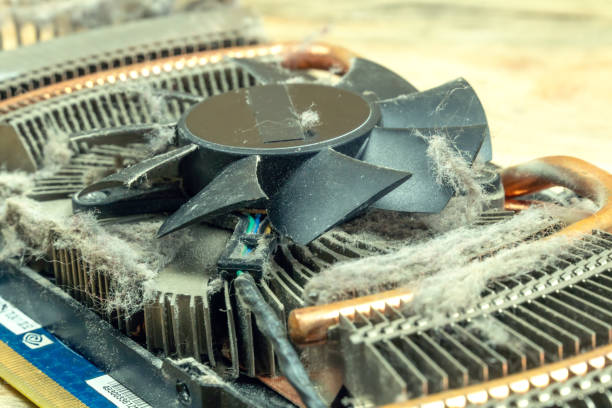 istock Dust on a CPU cooler close-up of a computer video card on a wooden table. 1254970047