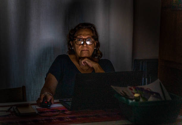 istock Attractive senior Hispanic at laptop 1254970798