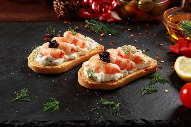 Prawns and Cream Cheese Canapes Prawns and Cream Cheese Canapes with festive decoration background shrimp cocktail stock pictures, royalty-free photos & images