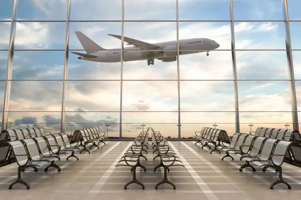 Photo of Empty airport terminal lounge with airplane on background.