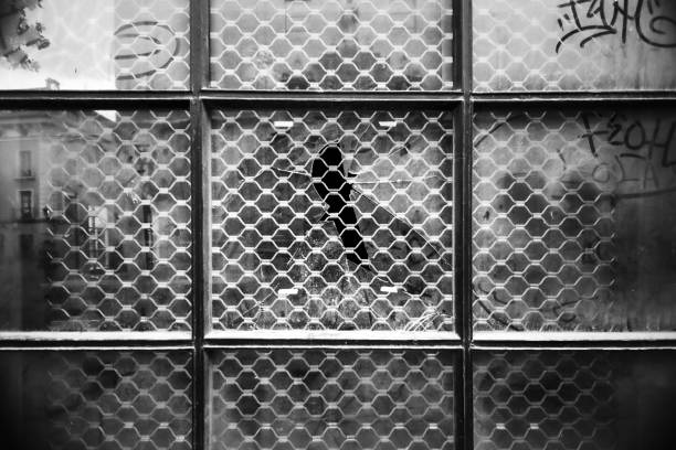 Window broken by a stone in an abandoned building