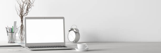 istock Workspace with laptop mock up. White desk and white wall. Front view. 1254974255
