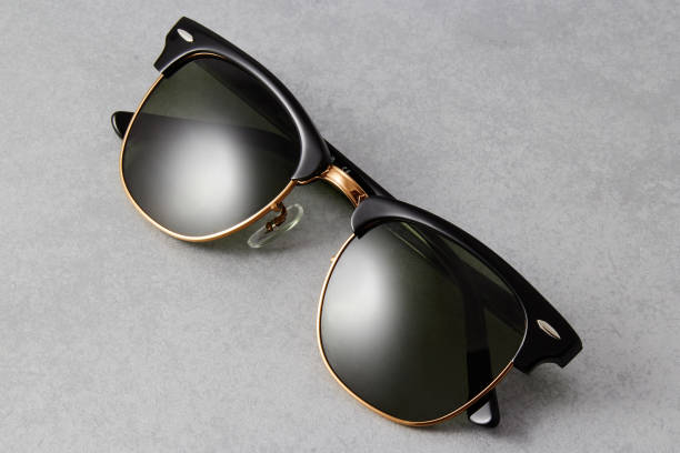 istock Classic sunglasses with a black frame and black lenses isolated on grey background. 1254976485