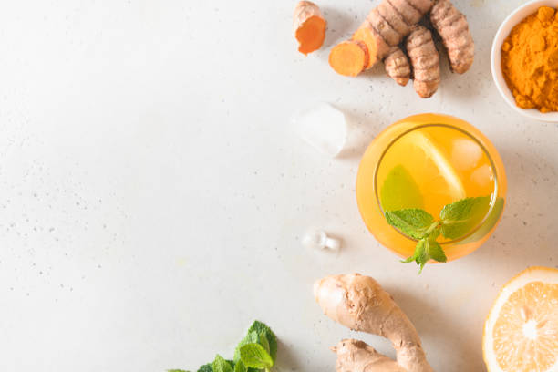 istock Jamu herbal beverage with natural ingredients turmeric, ginger on white background. Space for text. View from above. 1254977290