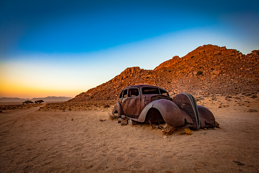 Riddled with rust and bullet holes, this enigmatic car sits on the side of a dirt track in the desert near Aus, Namibia.