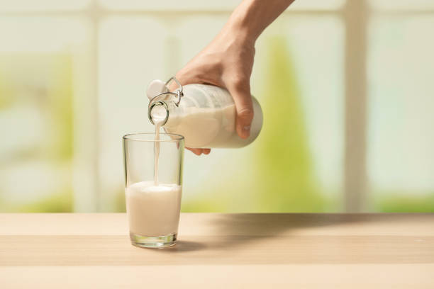 istock A woman's hand pours milk from a bottle into an empty glass 1254983882