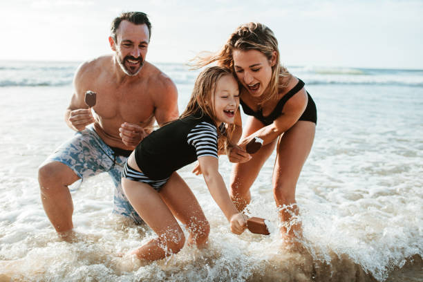 istock Family enjoying beach summer vacation 1254988363