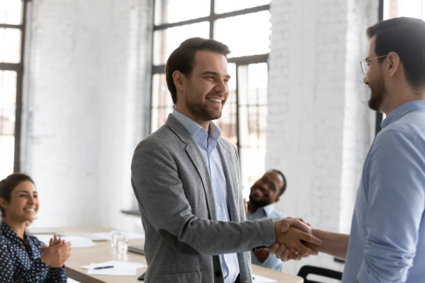 istock Two businessmen shake hands express respect accomplish negotiation 1254989163