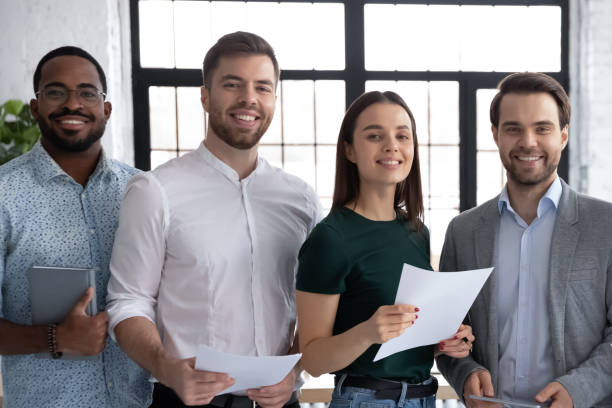 istock Diverse corporate business team pose in office looking at camera 1254989172