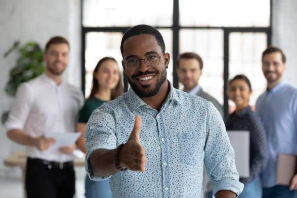 istock African sales manager stretch out hand introduces himself to client 1254989178