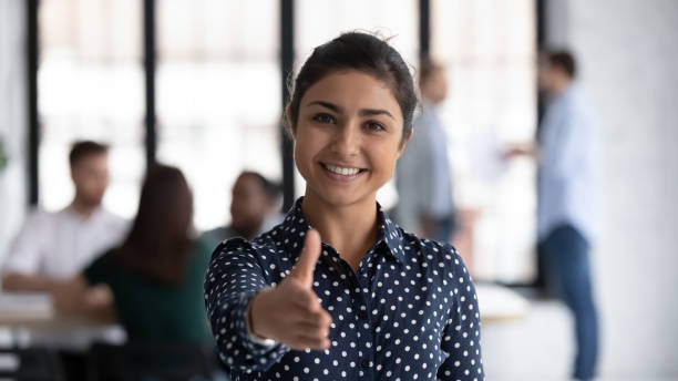 Friendly indian boss greeting client stretch out hand for handshake Head shot of friendly indian boss greeting client stretch out hand welcoming express amity good manners meet job vacancy applicant, first acquaintance, human resource HR manager recruiter work concept hand extended stock pictures, royalty-free photos & images