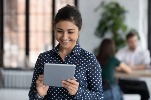istock Indian businesswoman look at tablet device screen preparing presentation 1254989191