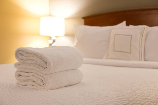 istock Cozy hotel room with bath towel on bed 1254989271
