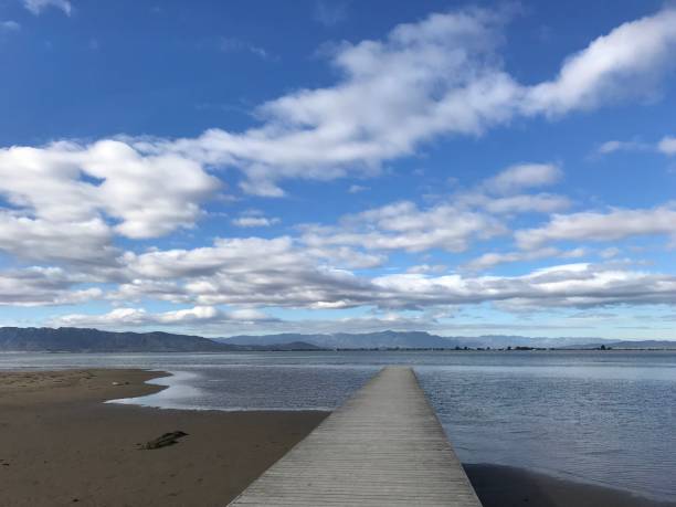 istock Sea dock and cloudy blue sky 1254989420