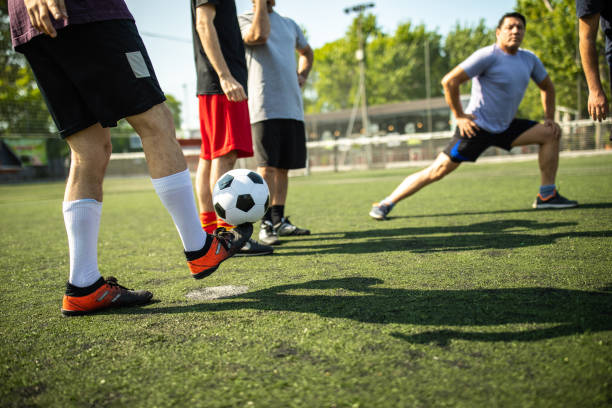 istock Male friends doing warm-up routine at soccer field 1254991430