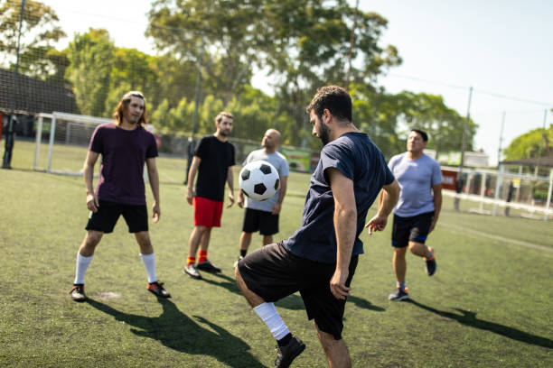 istock Male friends at soccer field 1254992321