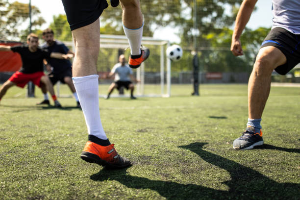 istock Soccer player trying to score a goal during friendly match 1254992339