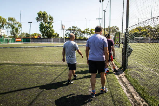 Friends entering sport field together