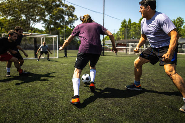 istock Men playing friendly match at soccer field 1254992577