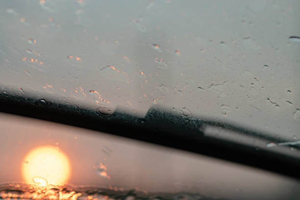istock Drops after rain rain on car glass in evening . Blurred background. 1254992688